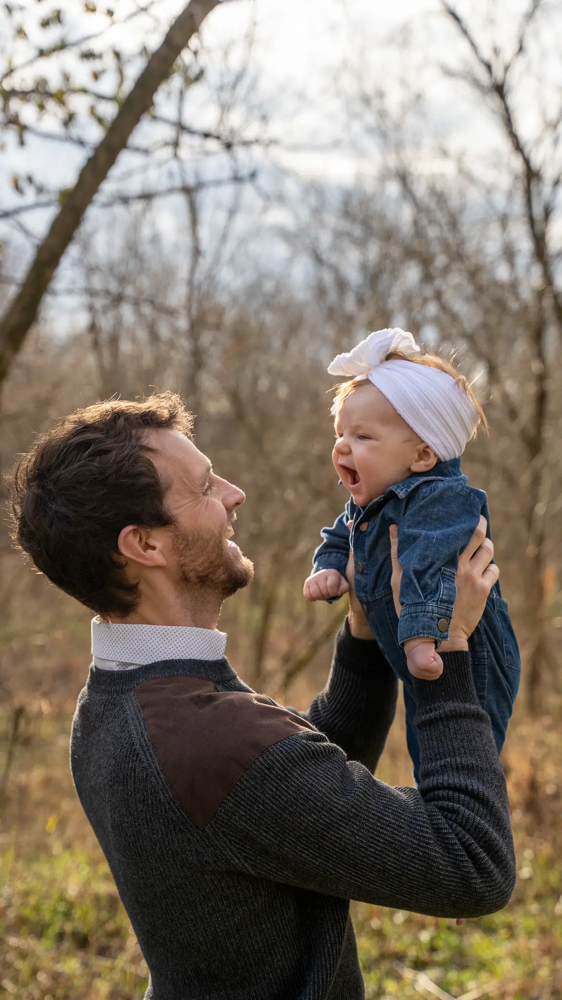 Dad lifting his baby daughter in the air